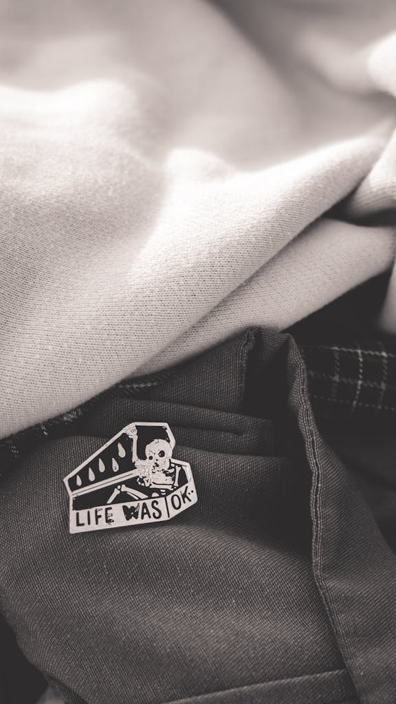 A close-up of fabric showcasing a unique logo patch with the text 'Life Was OK'.